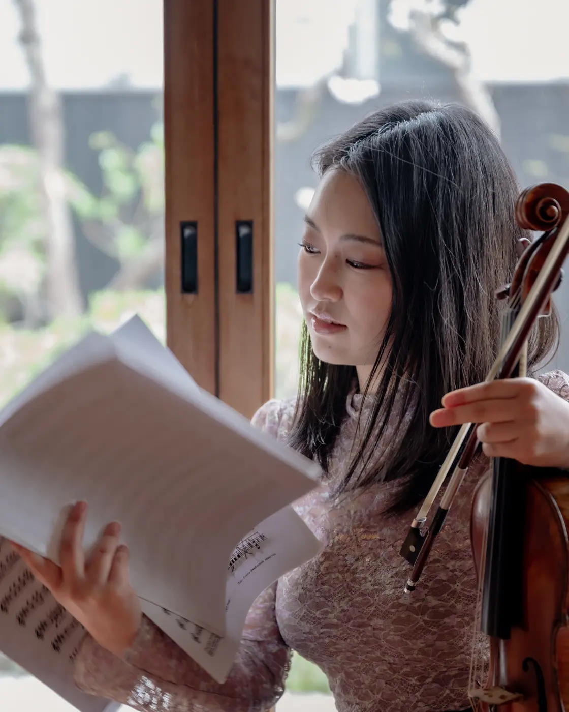 Reading sheet music by window